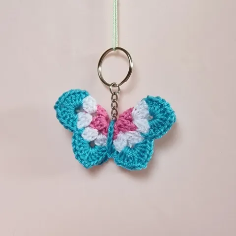 Nyckelring med en fjäril i färgen blåvit